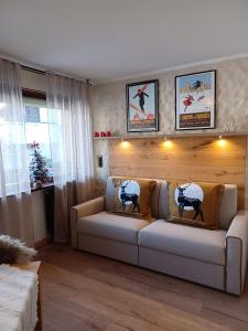 a living room with a couch and a christmas tree at Fradusta 213 in San Martino di Castrozza