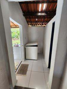 a hallway of a house with a small refrigerator at Serra do Matias in Maranguape