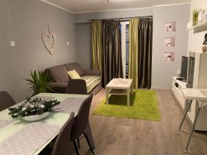 a living room with a couch and a table at LURKÓ Apartmanok Siófok in Siófok