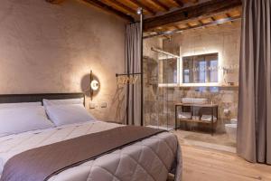 a bedroom with a large bed and a bathroom at Truffle House Tuscany Tuber Melanosporum Vitt in Montepulciano