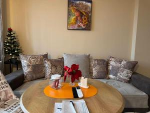 a living room with a table and a couch at Stadium Apartments in Veliko Tŭrnovo