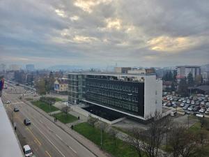 ein großes weißes Gebäude an der Seite einer Autobahn in der Unterkunft Apartman Teo Banja Luka in Banja Luka