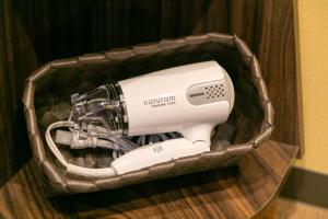 a hair dryer in a basket on a table at IKIDANE Cozy Hotel Haneda Airport - Vacation STAY 25834v in Tokyo