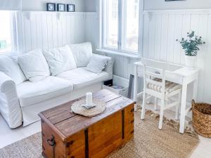 a living room with a white couch and a coffee table at Villa Primavera Apartment in Hanko in Hanko