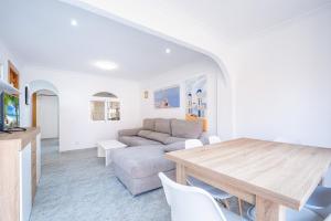 a living room with a table and a couch at Edimar 2-3 Apartment Levante Beach in Benidorm