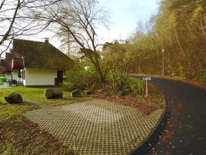 a house on a street with a sidewalk next to a road at Huis 38 Seepark Kirchheim in Kirchheim