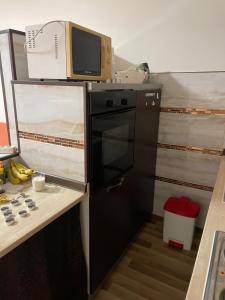 a microwave sitting on top of a refrigerator in a kitchen at Hidden Gem in Košice