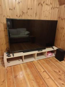 a large flat screen tv sitting on a stand at Chalet Edelweiss Marsia-Tagliacozzo 1500mt in Marsia