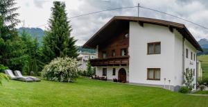 a house with a green lawn in front of it at Outdoor Lodge in Nauders