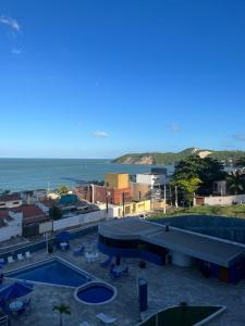 a view of a resort with a swimming pool and the ocean at FLAT 508 PARTICULAR - HOTEL in Natal