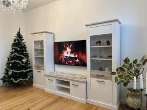 a living room with a tv and a christmas tree at Boardinghouse am Herforder Tor für 8 Personen auf 185 m2 in Bad Salzuflen