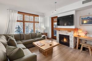 a living room with a couch and a fireplace at Capitol Peak 3317 in Aspen