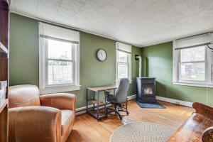 een woonkamer met groene muren en een tafel en een fornuis bij Quiet Port Royal Home with Deck, Near Juniata River! in Mifflintown