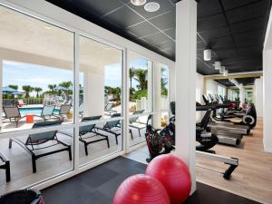 an indoor gym with treadmills and exercise equipment at Hilton Garden Inn Cocoa Beach-Oceanfront, FL in Cocoa Beach