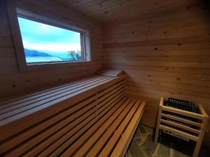 a sauna with a window and a wooden bench at MY TIME Holiday House with sauna in Zgornje Gorje