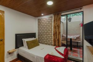 Ένα ή περισσότερα κρεβάτια σε δωμάτιο στο Casa Los Naranjos Hostal