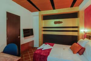 Ένα ή περισσότερα κρεβάτια σε δωμάτιο στο Casa Los Naranjos Hostal