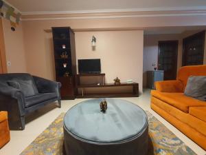 a living room with a couch and a coffee table at YOUVALA Serviced Apartments City Star in 6th Of October