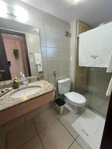 a bathroom with a sink and a toilet at FLAT 508 PARTICULAR - HOTEL in Natal