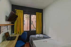 Ένα ή περισσότερα κρεβάτια σε δωμάτιο στο Casa Los Naranjos Hostal