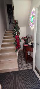 a staircase with a christmas tree and a piano at Porta Piccola Luxury Home in Bari