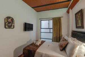 Ένα ή περισσότερα κρεβάτια σε δωμάτιο στο Casa Los Naranjos Hostal
