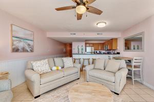 a living room with a couch and chairs and a table at Pelican Beach Resort 2003 in Destin