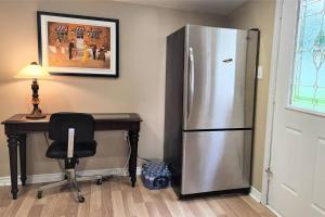 a kitchen with a desk and a stainless steel refrigerator at Skylight Waterfront home w/ amazing view/dock/boat in Lancaster