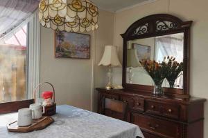 a bedroom with a table with a mirror and a dresser at Skylight Waterfront home w/ amazing view/dock/boat in Lancaster