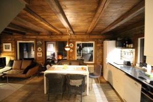 a kitchen and living room with a table and chairs at Lyngen Biarnes- Nordreisa in Hamnnes