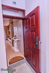 a red door in a room with a hallway at Shosholoza Homes in Wakiso