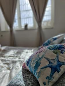 a bed with a pillow on top of it at Casa Gimaga in Pozzuoli