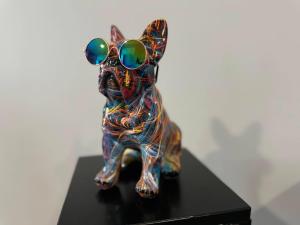 a colorful statue of a dog wearing sunglasses at Stadium Apartments in Veliko Tŭrnovo