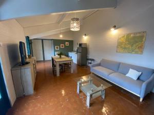 a living room with a couch and a table at Cottage les Écuries du faubourg in Béthune +13 photos