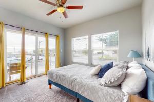 a bedroom with a bed and a ceiling fan at This Is It in Crescent City