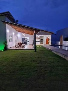 a large backyard with a pool and a house at Paraíso Natural, Guaratiba, Prado-BA in Prado