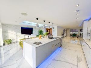 a kitchen with a sink and a tv on the wall at The Firs in Boston