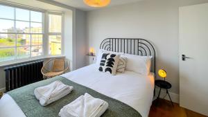 a bedroom with a white bed with pillows and a window at Old Town Trinity Apt No 4 By Adliv Host in Margate