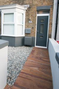 a front door of a house with a gravel walkway at Stylish Home Close To The Beach By Adliv Host in Margate