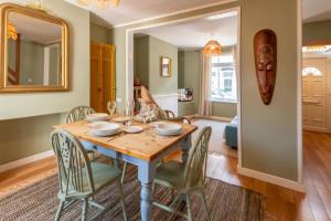 a dining room with a table with chairs and a mirror at 3-bed Hidden Gem Of A Cottage In Margate in Margate