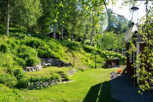 a yard with a hill with a house on it at House in Tärnaby in Tärnaby