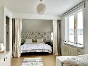 a bedroom with a bed and two windows at House in Tärnaby in Tärnaby