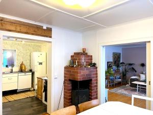 a kitchen and a living room with a brick fireplace at House in Tärnaby in Tärnaby