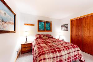 a bedroom with a bed and two night stands and two lamps at Alpine Bliss in Brownsville