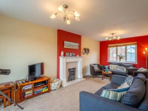 a living room with a couch and a tv at 4 Bed in Camber BT091 in Camber