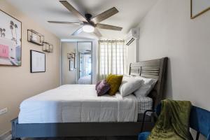 a bedroom with a bed with a ceiling fan at Fortuna Paradise in Luquillo