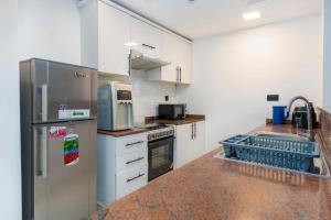 a kitchen with a stainless steel refrigerator and a dishwasher at 1 Bedroom- Heart of Marina - Marina Diamond 1 in Dubai