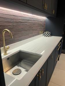 um balcão de cozinha com um lavatório na cozinha em Eastgate Rows Apartments em Chester