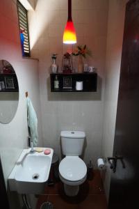 a bathroom with a white toilet and a sink at Casa em Condomínio Estrada de São Roque Estrada do Vinho in São Roque