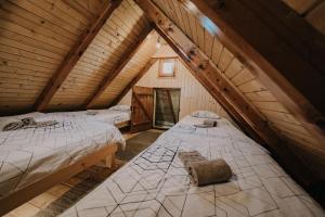a room with two beds in a attic at Koča Ojstrica - Velika planina in Stahovica